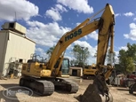 Used Komatsu Excavator under blue sky